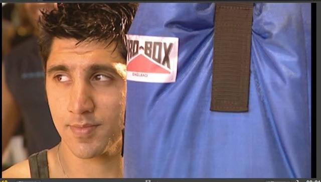 Mak Singh beside a punch bag in a gym scene, 2002