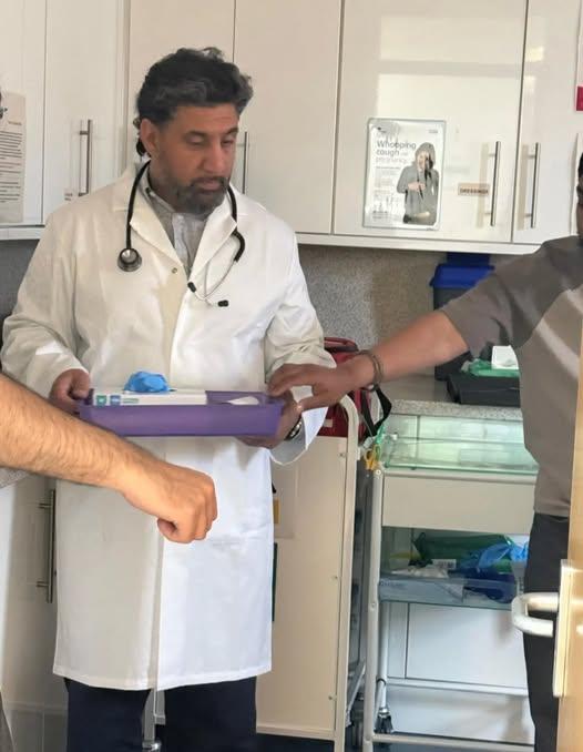 Mak Singh in costume as a doctor on set, 2026